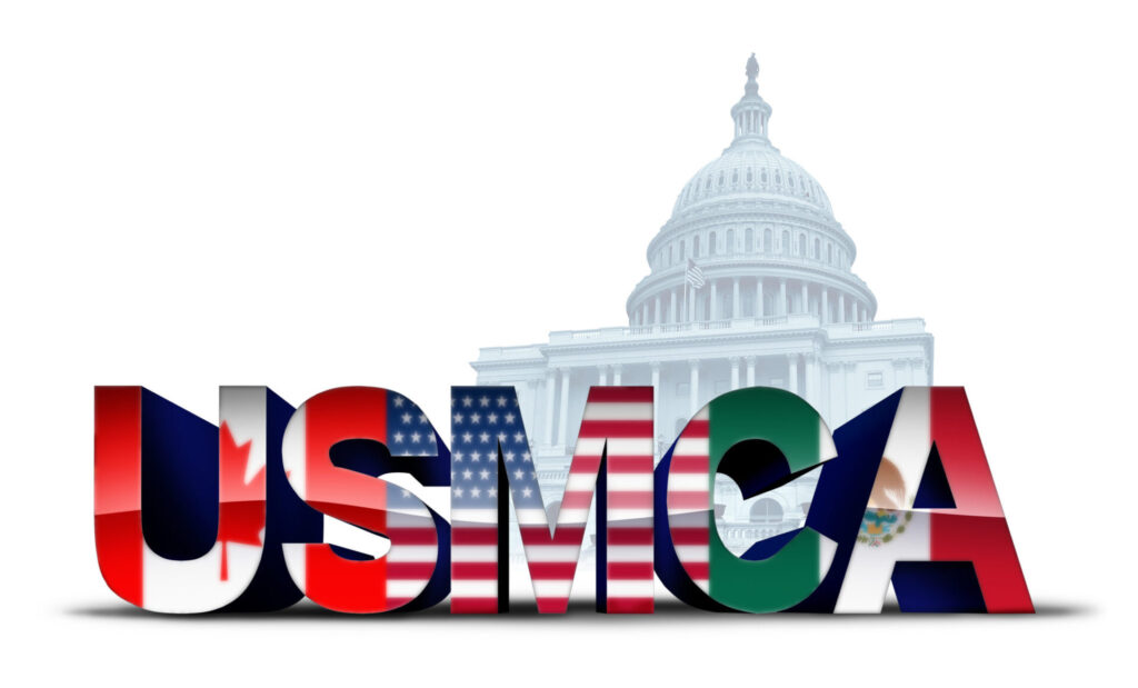 3D text "USMCA" with flags of Canada, the US, and Mexico, in front of US Capitol building.